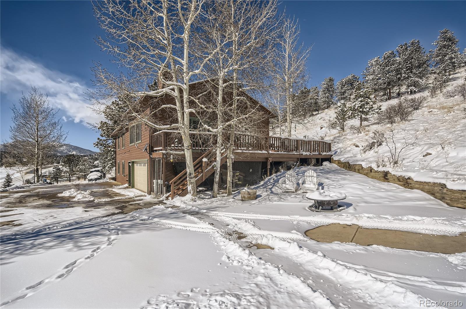 1749 County Road 72 Bailey, CO 80421 - Photo 2 of 35 a view of a house with snow on the road