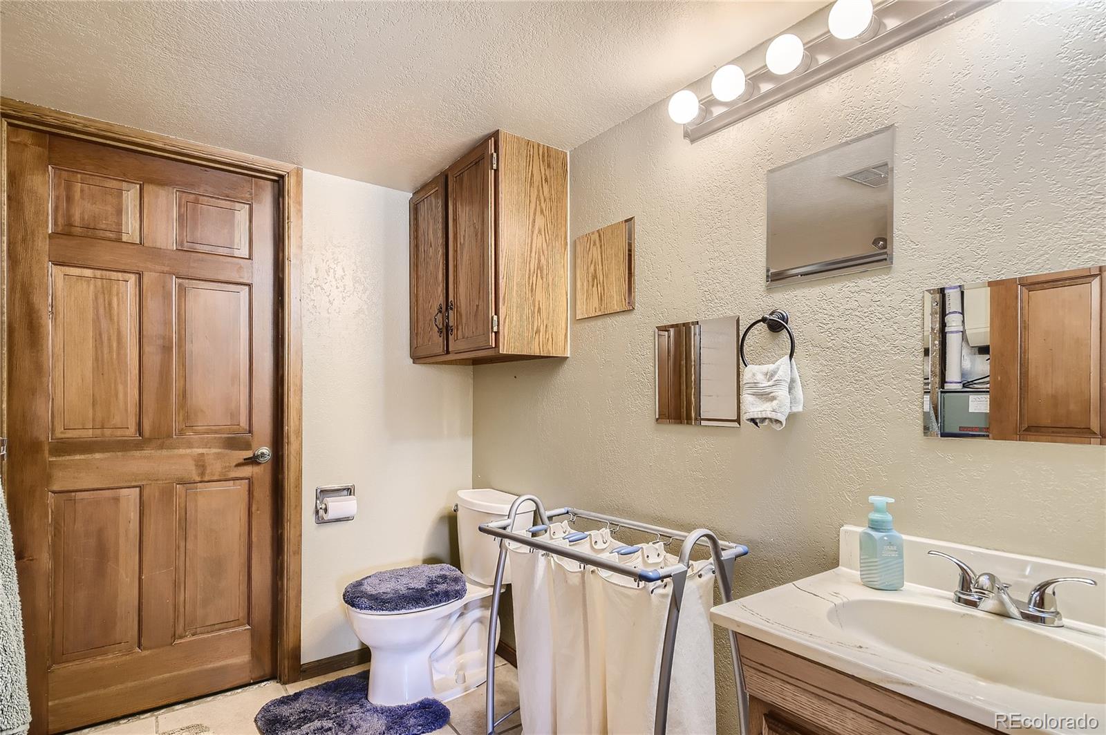 1749 County Road 72 Bailey, CO 80421 - Photo 22 of 35 a bathroom with a sink toilet and shower