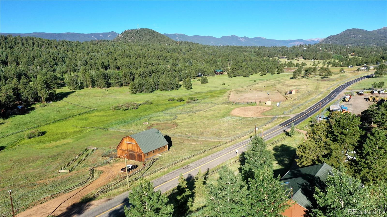 1749 County Road 72 Bailey, CO 80421 - Photo 32 of 35 a view of a lush green hillside and a houses