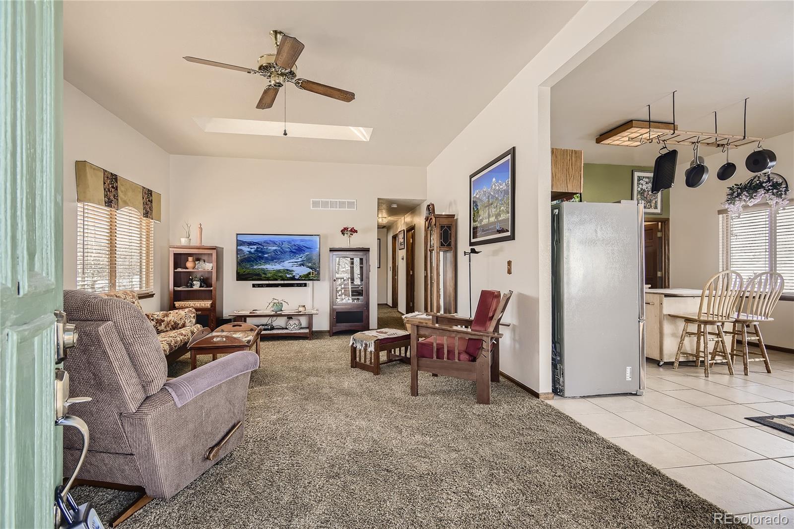 1749 County Road 72 Bailey, CO 80421 - Photo 5 of 35 a living room with furniture and a flat screen tv