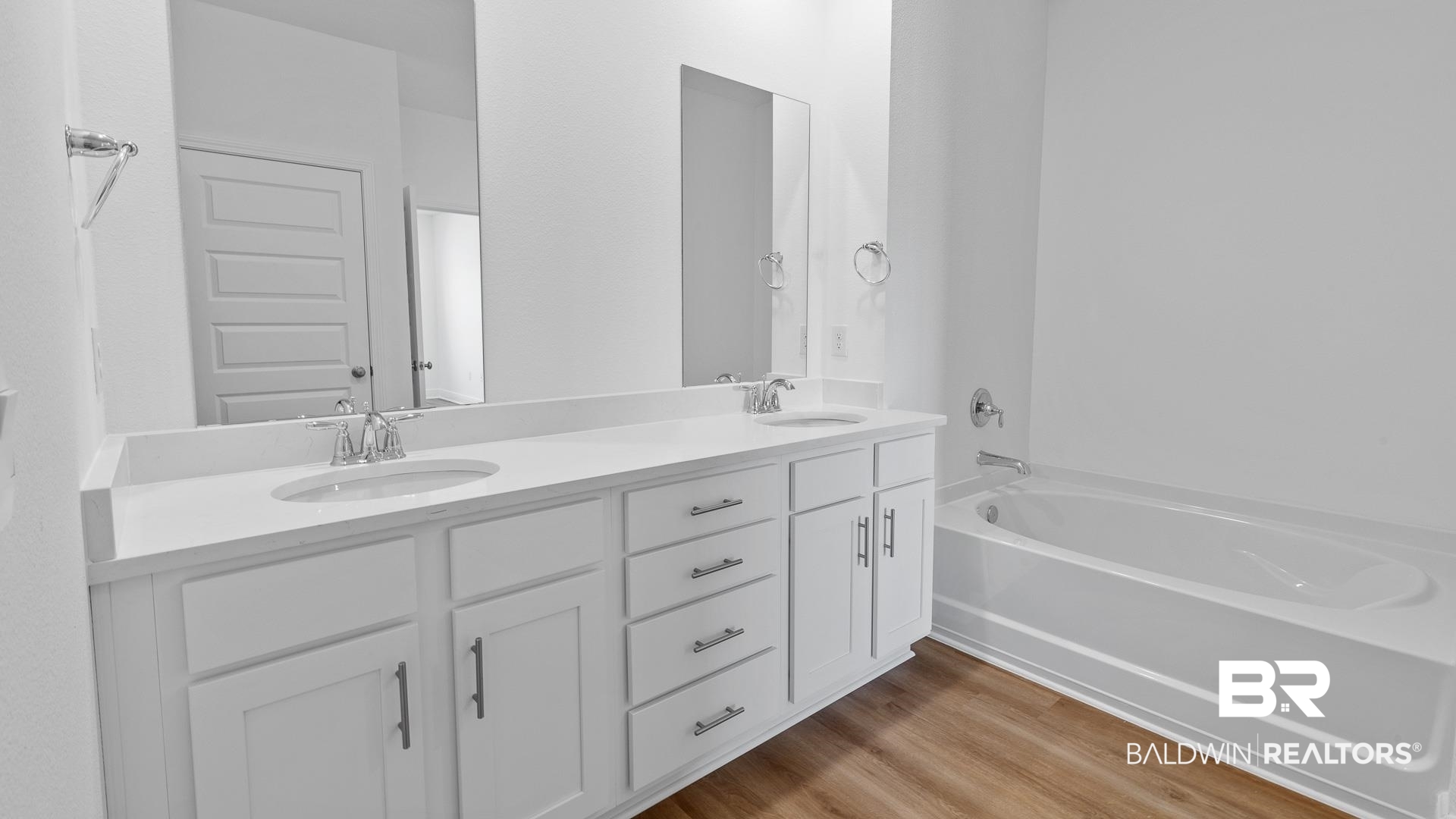 12931 Grand Rpds Road Fairhope, AL 36532 - Photo 26 of 33 Full bath with double vanity, a garden tub, wood finished floors, and a sink