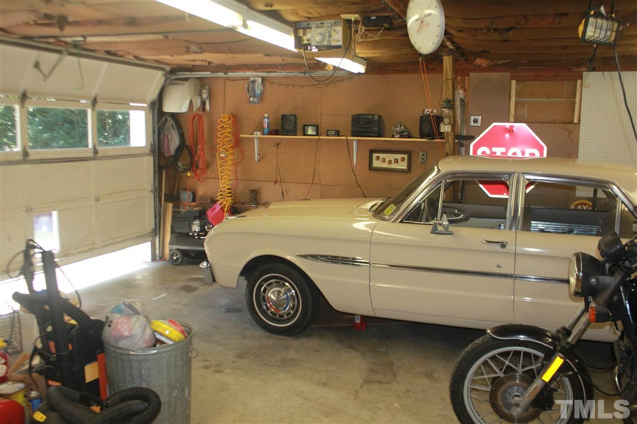 301 Northfield Drive Raleigh, NC 27609 - Photo 21 of 24 a view of a garage and car parked