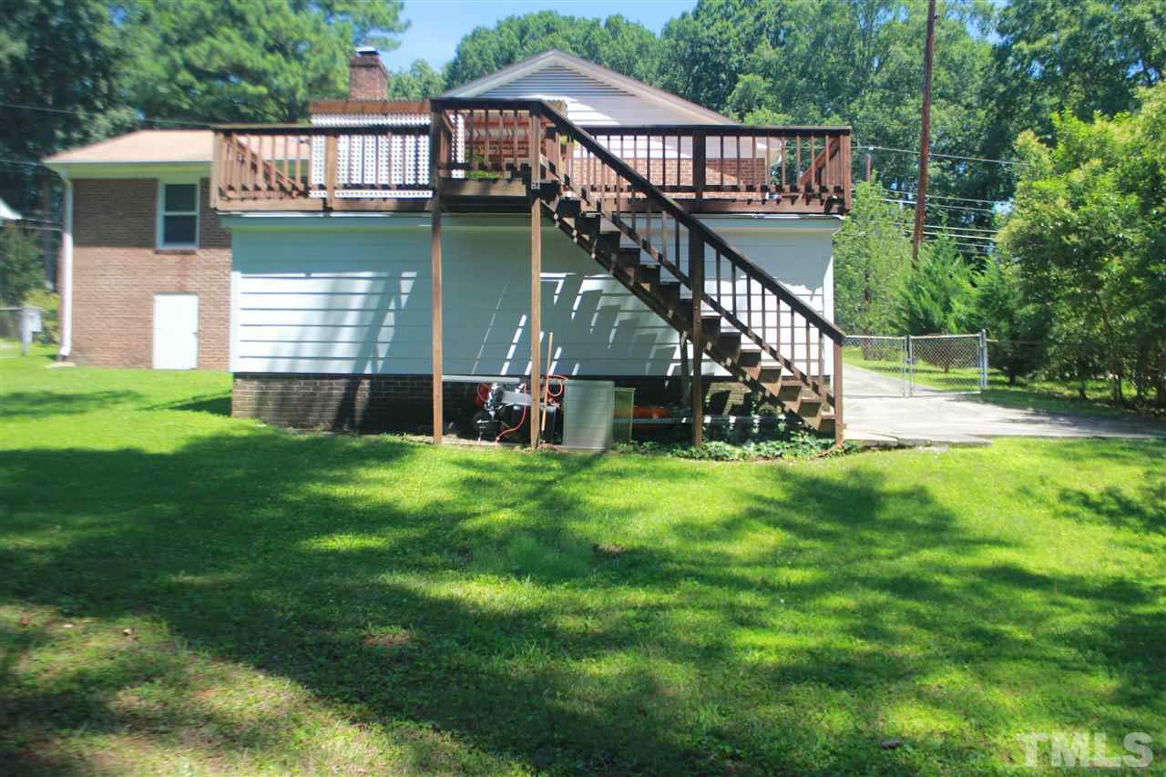 301 Northfield Drive Raleigh, NC 27609 - Photo 23 of 24 a view of a house with a backyard and a deck