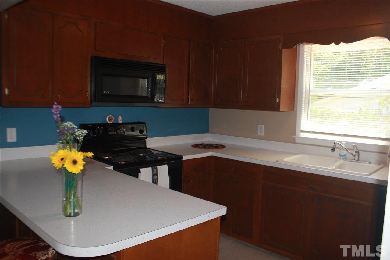 301 Northfield Drive Raleigh, NC 27609 - Photo 5 of 24 a kitchen with a sink a stove and cabinets