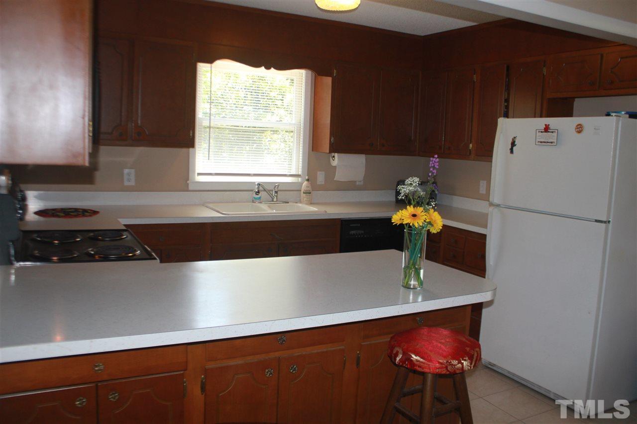 301 Northfield Drive Raleigh, NC 27609 - Photo 6 of 24 a kitchen with a refrigerator a sink and a stove