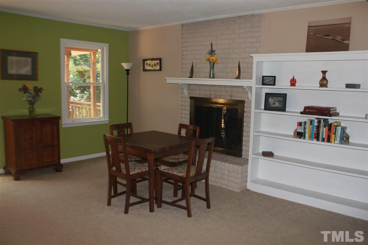 301 Northfield Drive Raleigh, NC 27609 - Photo 8 of 24 a view of a dining room with furniture and a fireplace