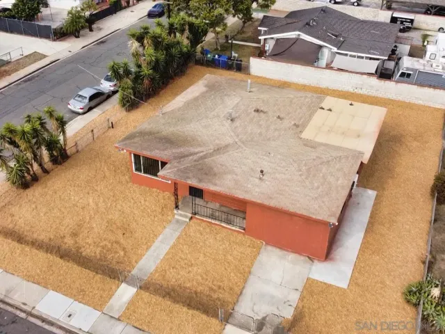 an aerial view of a house with a yard
