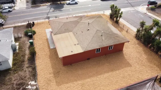 an aerial view of a house with garden space and street view