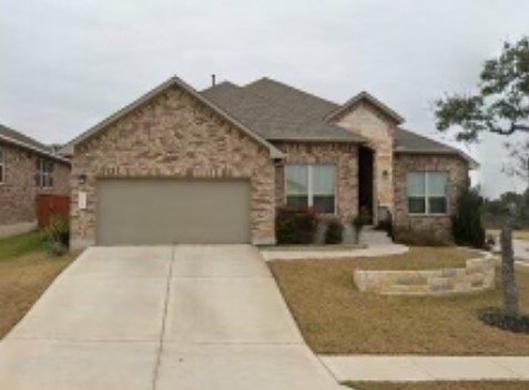 Ranch-style home with a garage and driveway