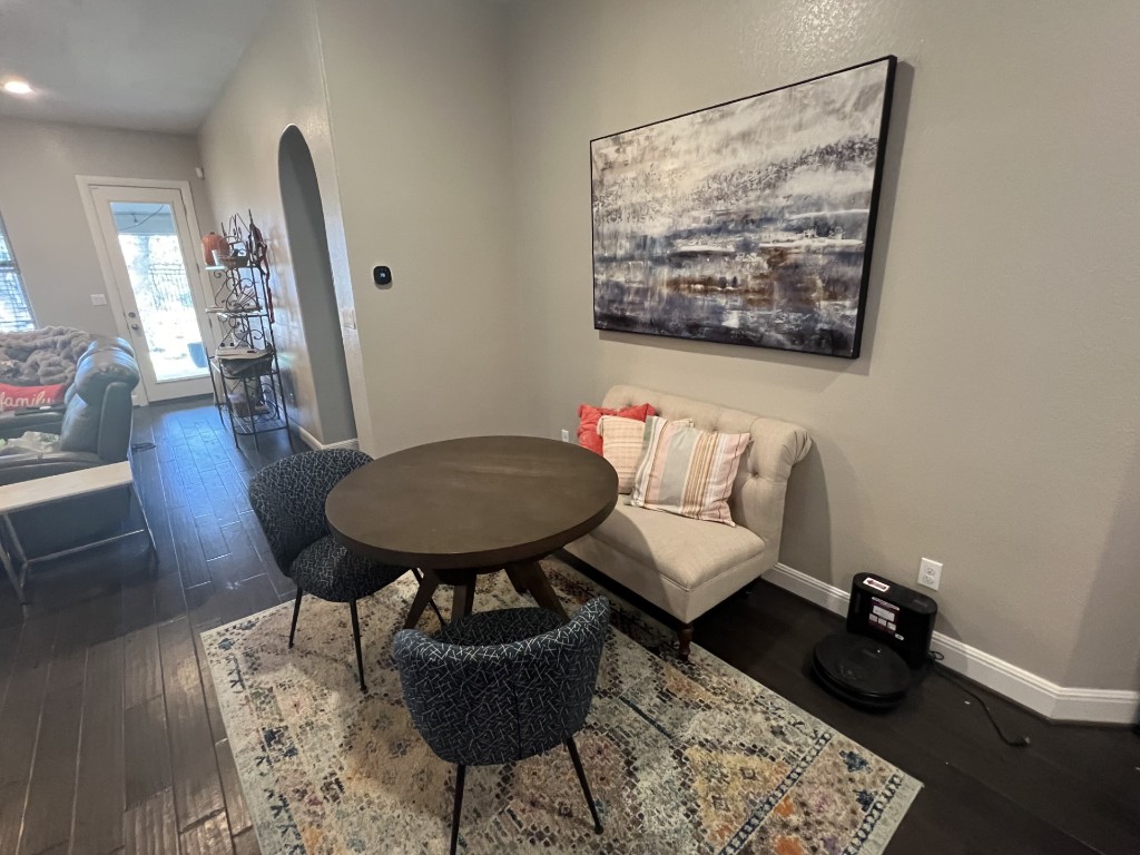 404 Peakside Circle Dripping Springs, TX 78620 - Photo 5 of 9 Dining room with arched walkways and dark wood finished floors
