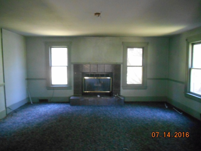 2697 North Unity Road Lena, IL 61048 - Photo 12 of 16 an empty room with windows and fireplace