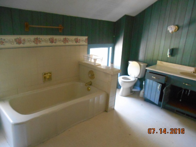 2697 North Unity Road Lena, IL 61048 - Photo 14 of 16 a bathroom with a sink a toilet and bathtub
