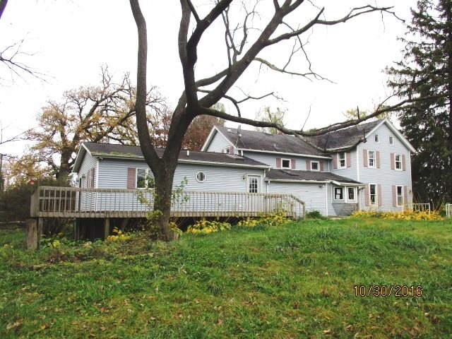 2697 North Unity Road Lena, IL 61048 - Photo 5 of 16 a white house that has a tree in front of it
