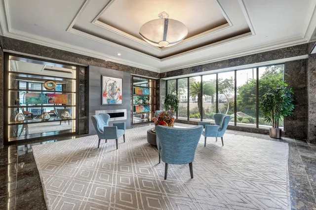 a living room with furniture and a floor to ceiling window