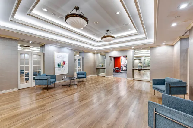 a lobby with furniture and mirror