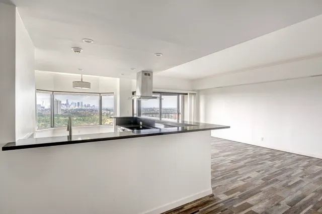 a view of a kitchen with a sink and window