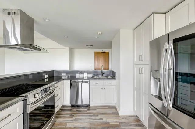a kitchen with stainless steel appliances a refrigerator stove and sink