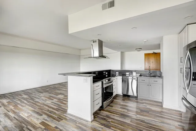 a kitchen with a stove and a refrigerator