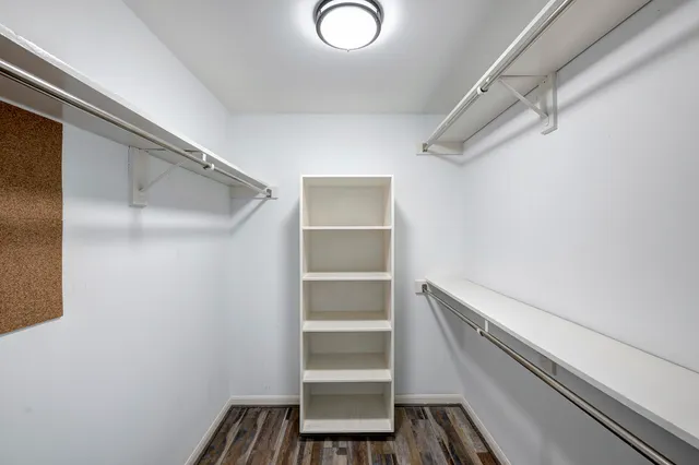 a view of walk in closet with empty racks