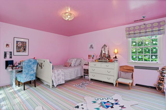 a bedroom with furniture and a window