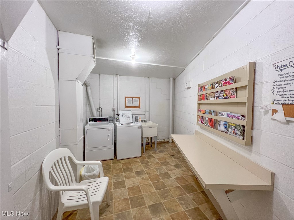 315 Solon Road, Unit 307 Chagrin Falls, OH 44022 - Photo 15 of 15 Laundry room with a textured ceiling and washing machine and clothes dryer