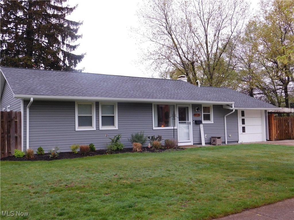 9720 West Ridgewood Drive Parma Heights, OH 44130 - Photo 31 of 46 Ranch-style house featuring a front lawn, a shingled roof, an attached garage, and fence