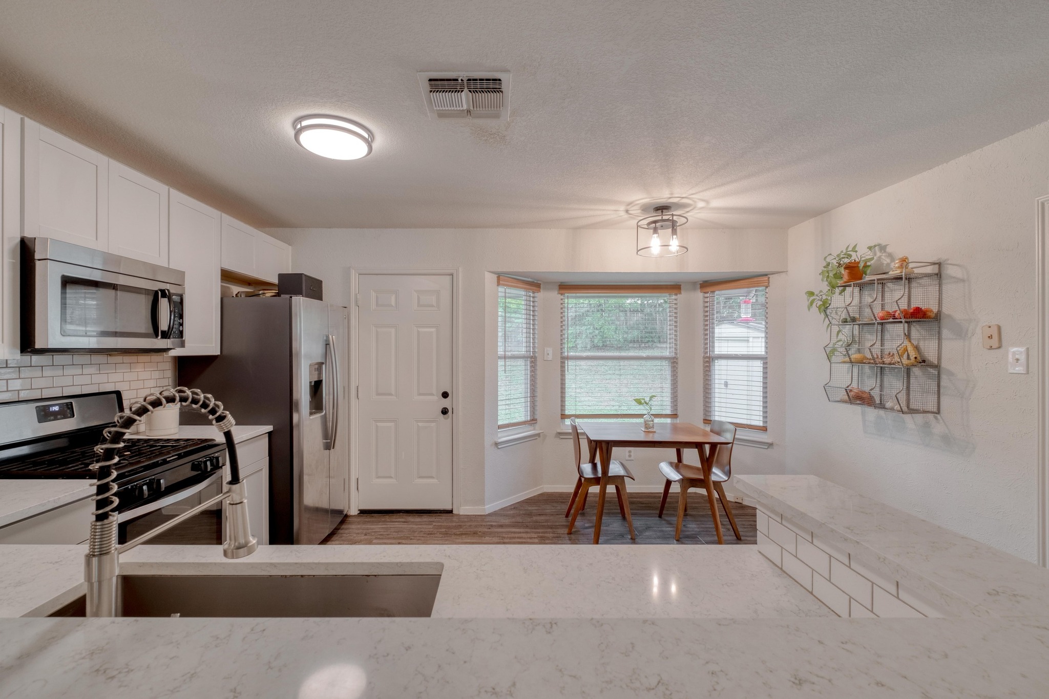 12030 Rotherham Drive Austin, TX 78753 - Photo 9 of 19 Bright, open kitchen flows seamlessly into a cheerful eat-in kitchen with backyard views.