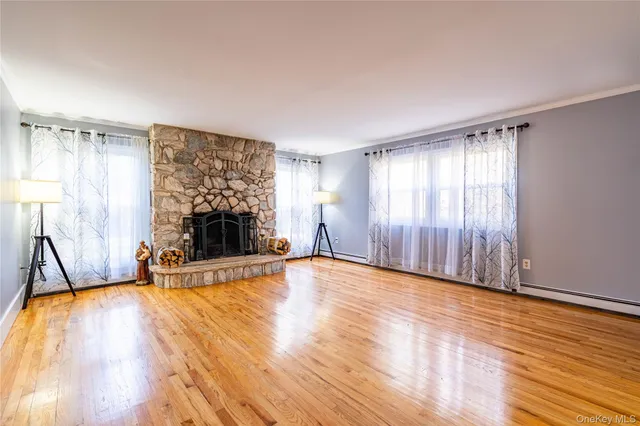 a view of a livingroom with a fireplace and window