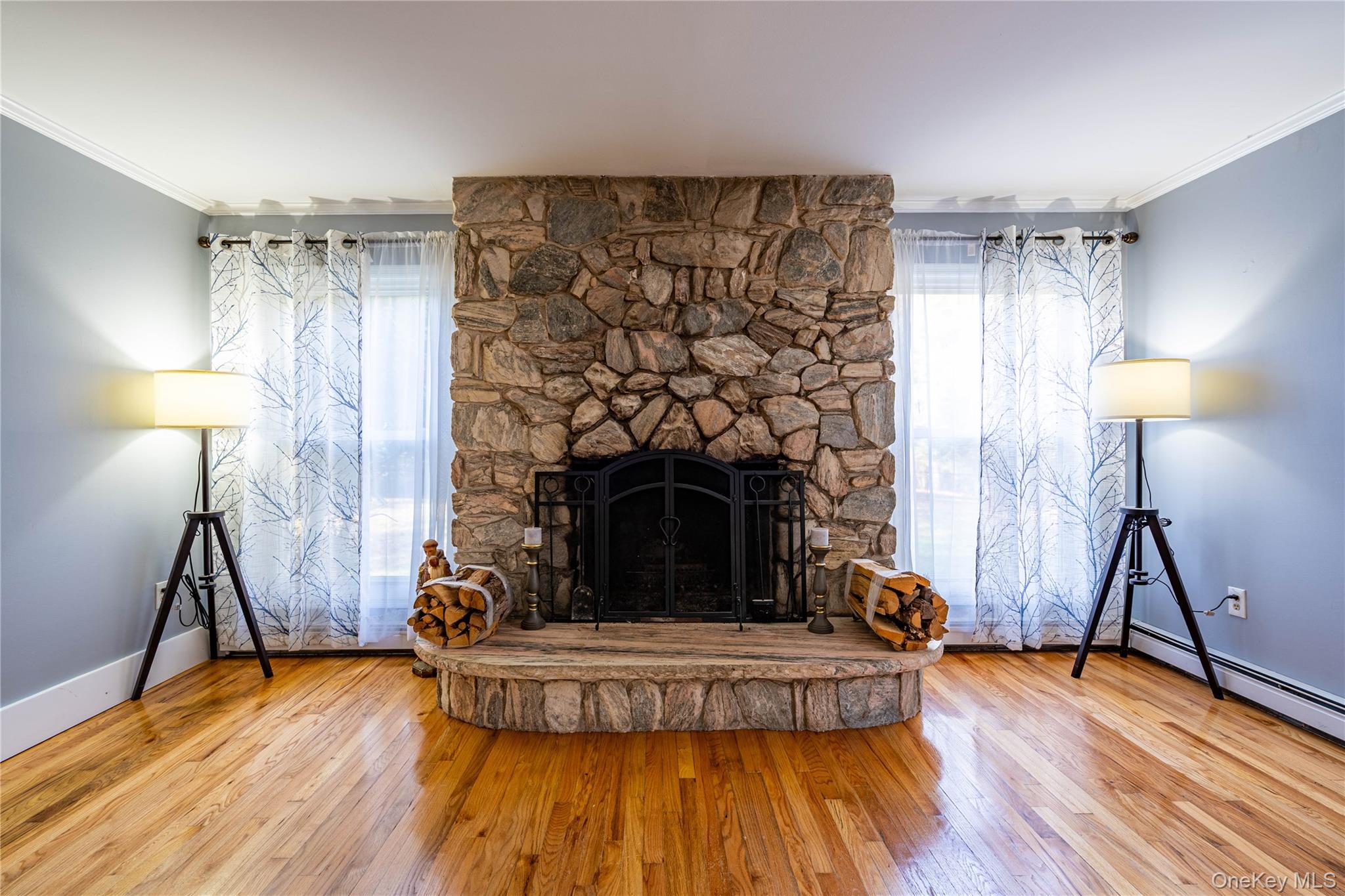 67 Whitlock Road Otisville, NY 10963 - Photo 14 of 50 a living room with a fireplace and wooden floor