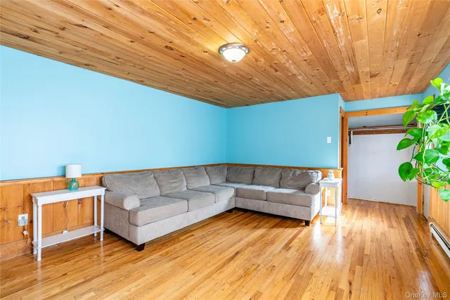 a living room with a couch and a potted plant