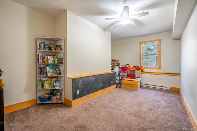 a living room with furniture and a book shelf