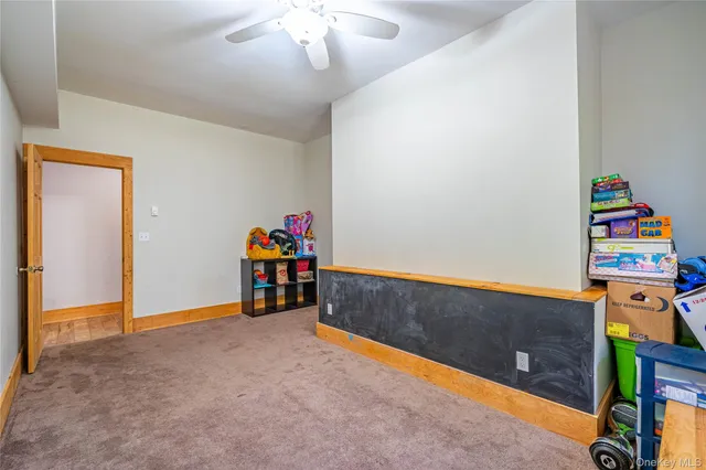 a view of game room with toys and dresser