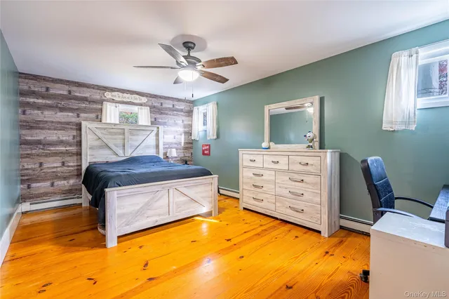 a living room with a dresser and a window