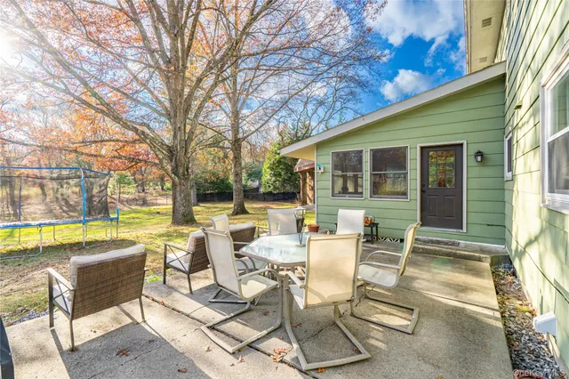 a view of swimming pool with outdoor seating and city view