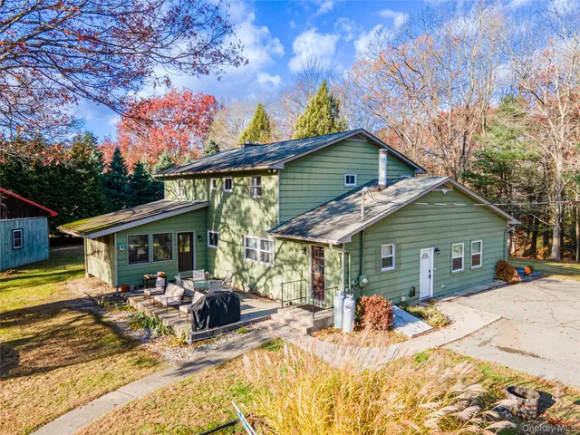 a view of a dinning table and chairs in patio of the house