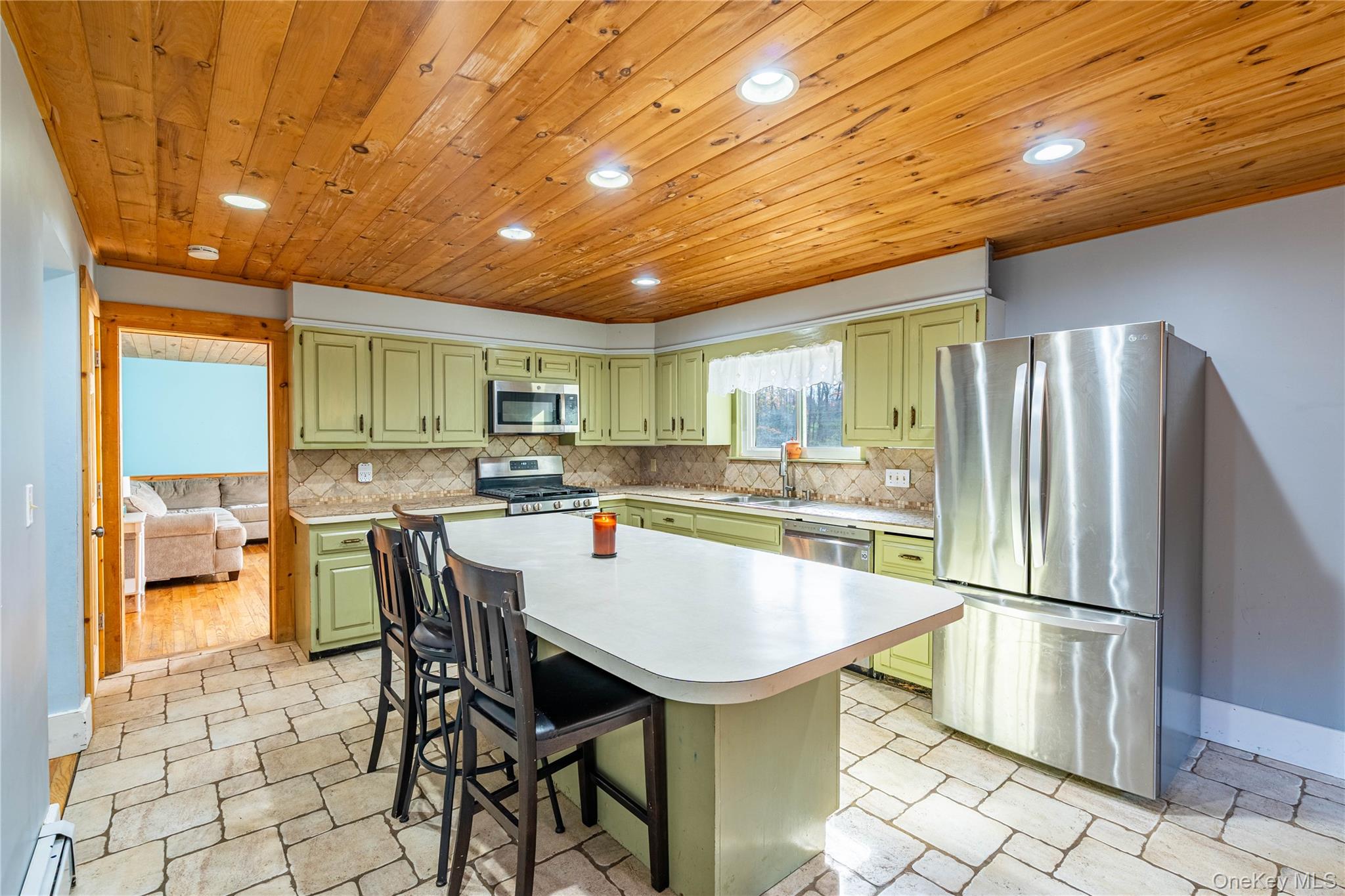 67 Whitlock Road Otisville, NY 10963 - Photo 6 of 50 a kitchen with granite countertop a table chairs stove and refrigerator