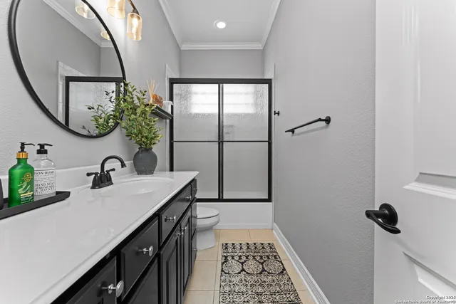 a bathroom with a sink a mirror and a shower