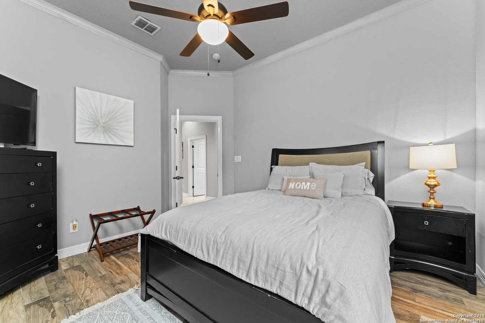 27906 Bogen Road New Braunfels, TX 78132 - Photo 17 of 49 a bedroom with a bed and a lamp on dresser