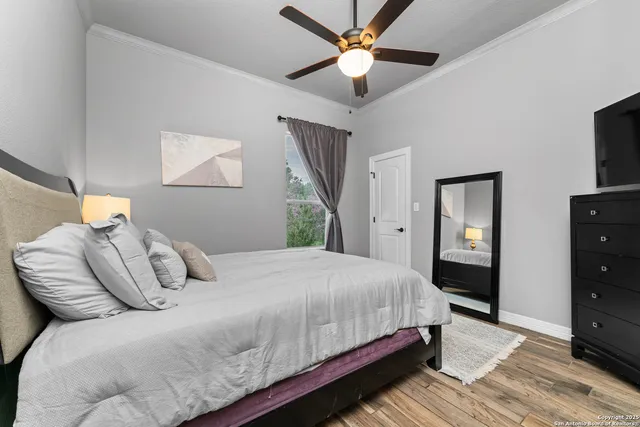 a bedroom with a bed and a tv on the dresser