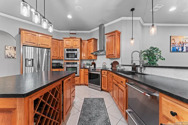 a large kitchen with stainless steel appliances granite countertop a lot of counter space and a sink