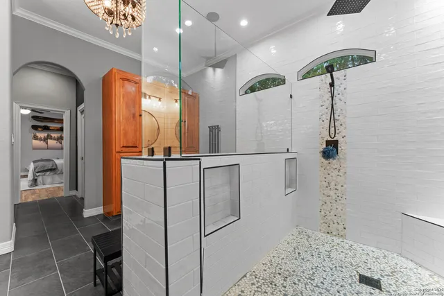 a bathroom with a shower a sink and a mirror