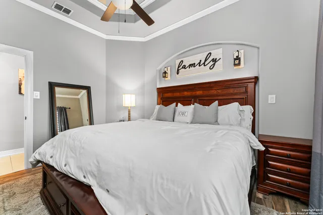a bedroom with a bed and a ceiling fan