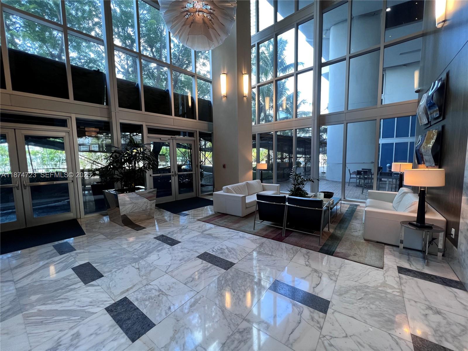 185 Southwest 7th Street, Unit 4204 Miami, FL 33130 - Photo 28 of 32 a living room with furniture and a potted plant