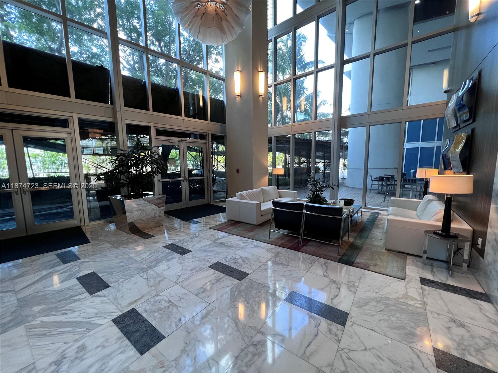 185 Southwest 7th Street, Unit 4204 Miami, FL 33130 - Photo 29 of 32 a living room with furniture and a potted plant