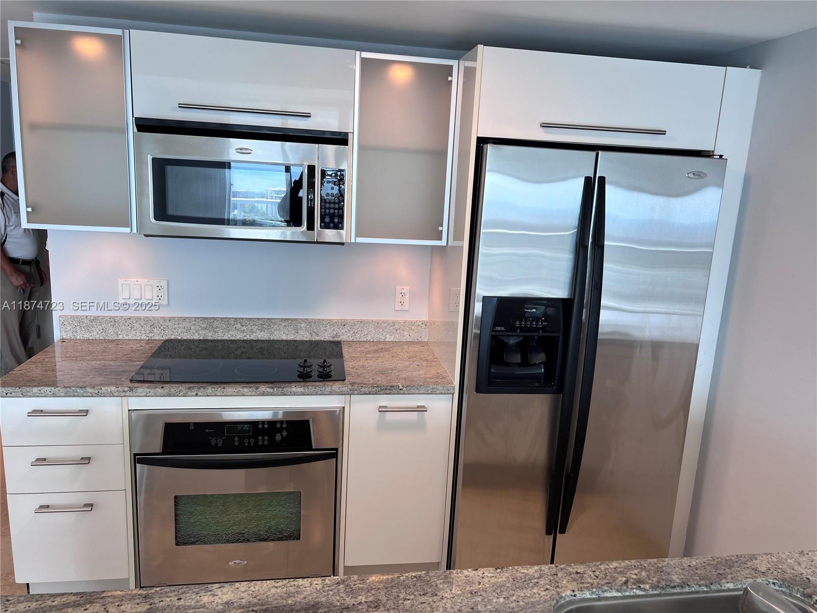 185 Southwest 7th Street, Unit 4204 Miami, FL 33130 - Photo 6 of 32 a kitchen with stainless steel appliances kitchen island a stove and a refrigerator