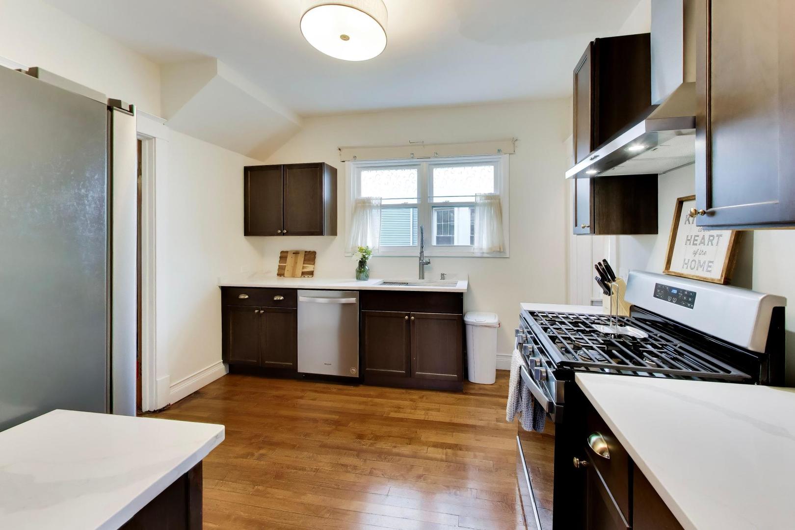 3533 Grand Boulevard Brookfield, IL 60513 - Photo 11 of 40 a kitchen with stainless steel appliances granite countertop a stove and a refrigerator