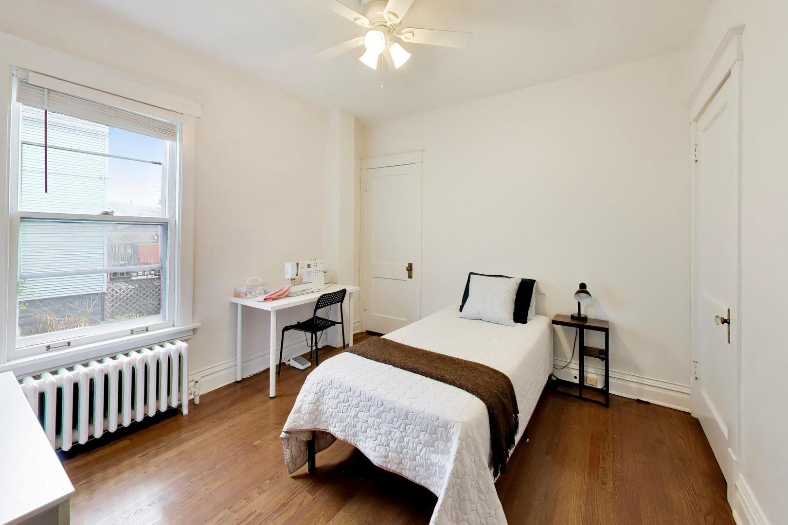 3533 Grand Boulevard Brookfield, IL 60513 - Photo 17 of 40 a bedroom with a bed and a table in it