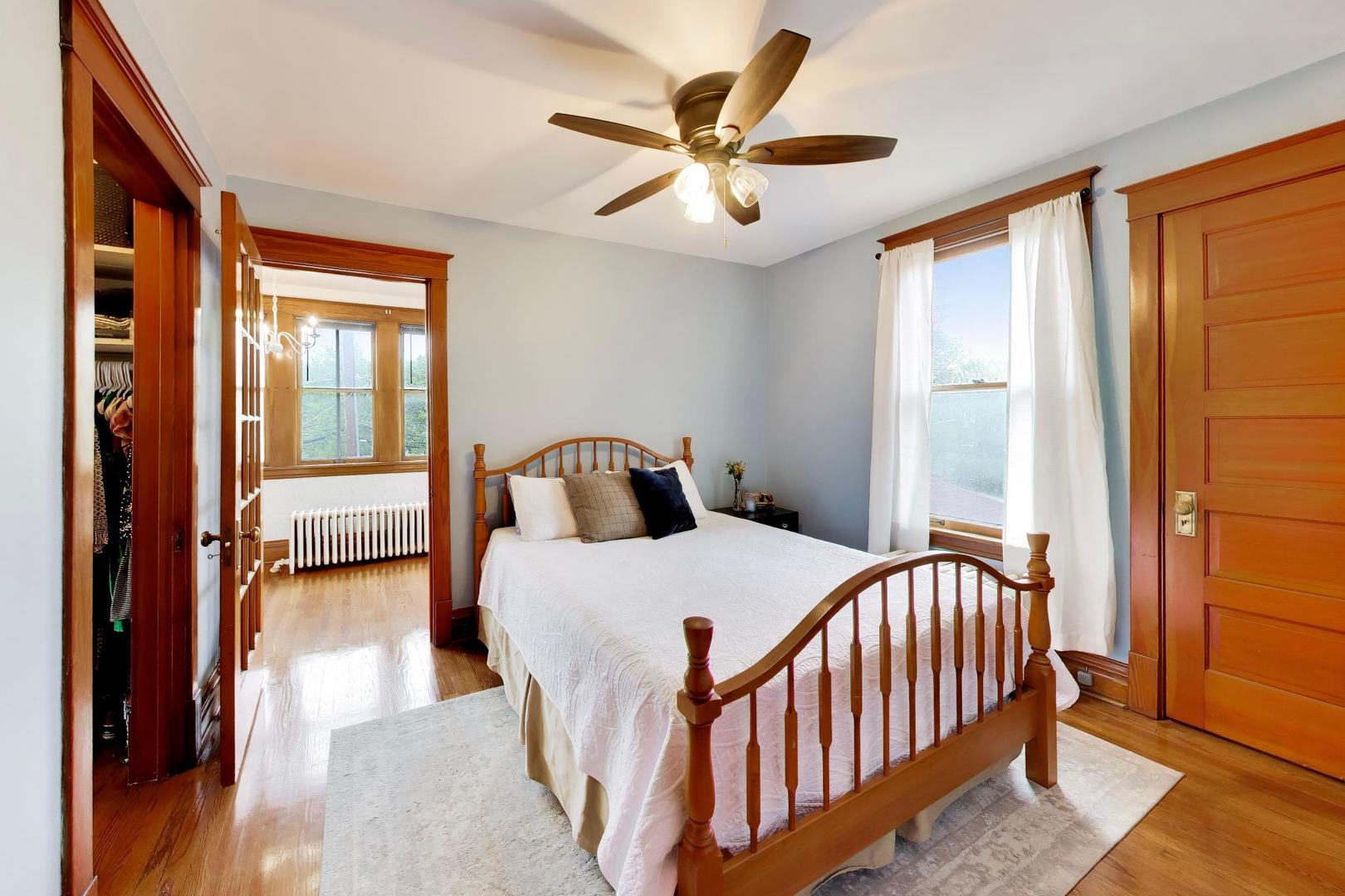 3533 Grand Boulevard Brookfield, IL 60513 - Photo 21 of 40 a bedroom with a bed and a large window with wooden floor