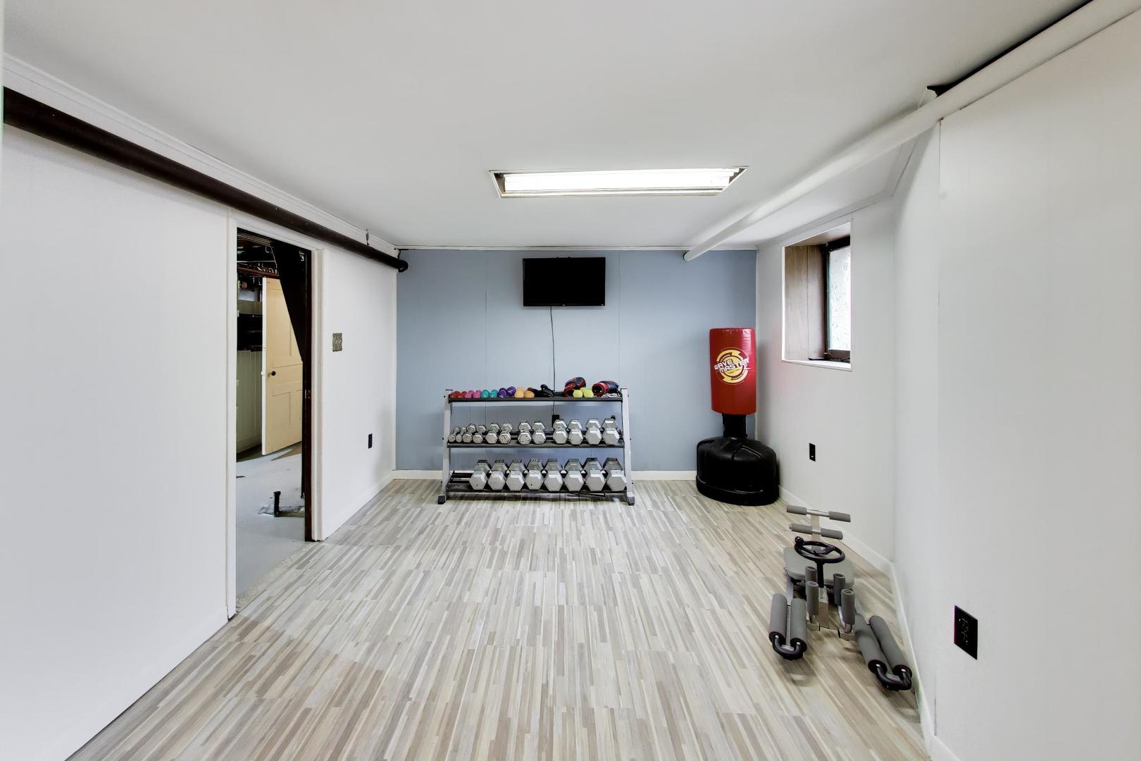 3533 Grand Boulevard Brookfield, IL 60513 - Photo 32 of 40 a room with wooden floor and gym equipment