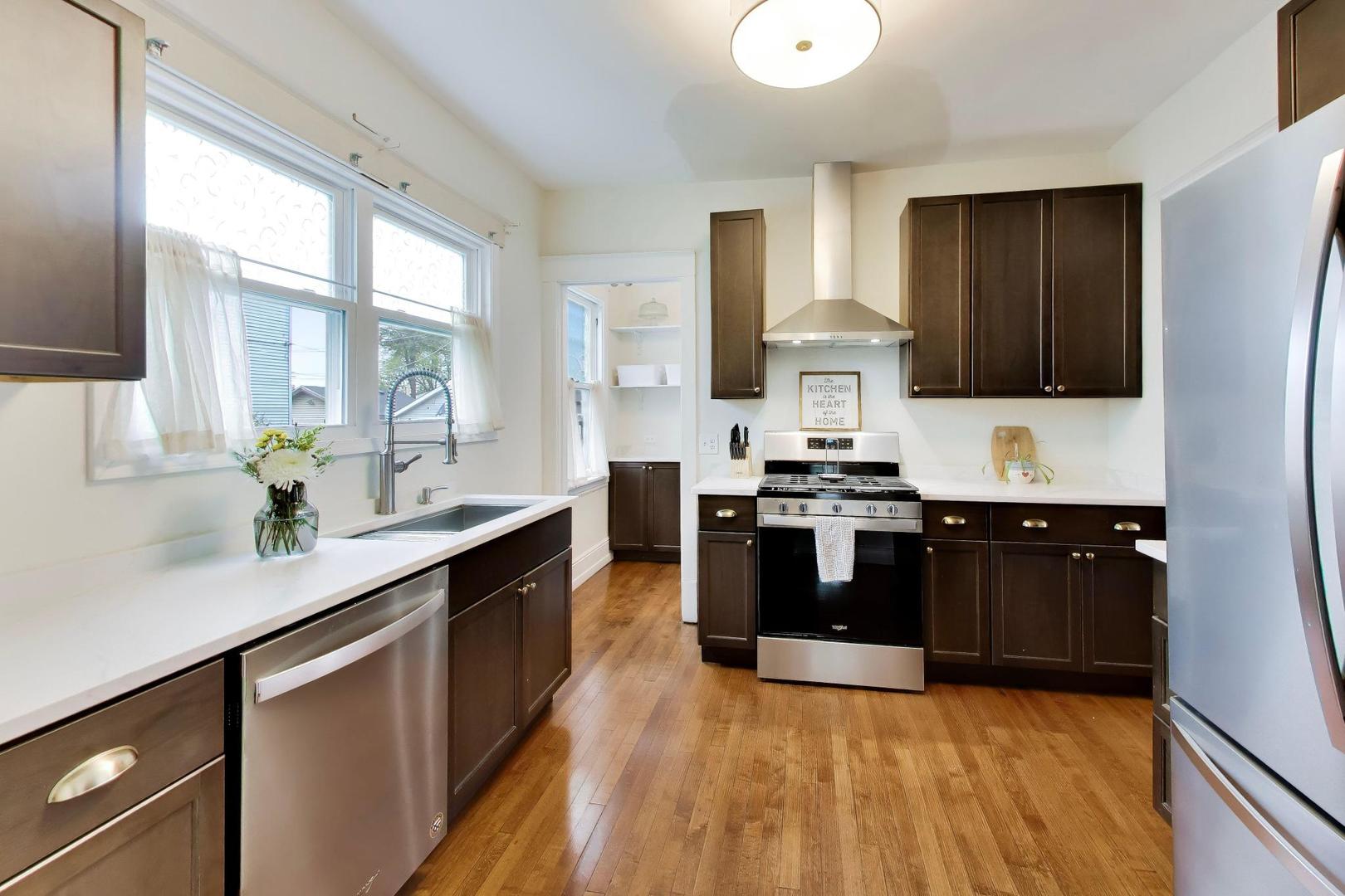 3533 Grand Boulevard Brookfield, IL 60513 - Photo 10 of 40 a kitchen with kitchen island granite countertop a sink cabinets and stainless steel appliances